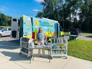 image of Mobile CDL with staff member behind book carts and table